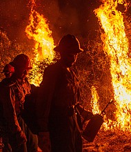 Rain could bring relief to thousands of firefighters battling blazes across the West Coast./Credit:	David McNew/Getty Images