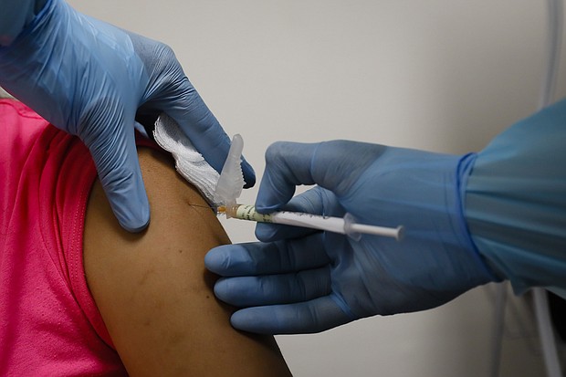 A health worker injects a woman during clinical trials for a Covid-19 vaccine at Research Centers of America in Hollywood, Florida, U.S., on Wednesday, Sept. 9, 2020. Photographer: Eva Marie Uzcategui/Bloomberg via Getty Images/Credit: Eva Marie Uzcategui/Bloomberg via Getty Images