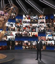 Host Jimmy Kimmel appears with a screen filled with nominees during the 72nd Emmy Awards broadcast. (The Television Academy and ABC Entertainment via AP)/Credit: The Television Academy and ABC Entertainment via AP