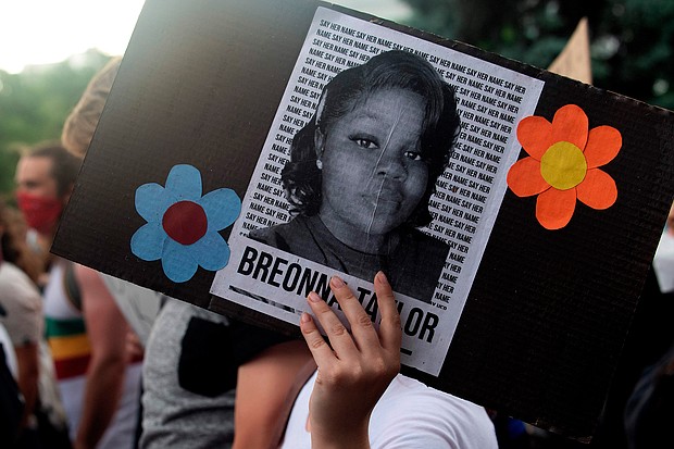 A demonstrator holds a sign with the image of Breonna Taylor, a black woman who was fatally shot by Louisville Metro Police Department officers, during a protest against the death George Floyd in Minneapolis, in Denver, Colorado on June 3, 2020./Credit:	Jason Connolly/AFP/Getty Images