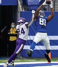 Indianapolis Colts tight end Mo Alie-Cox (81) makes a catch Sunday against the Minnesota Vikings’ Holton Hill (24) during the second half of their game in Indianapolis.