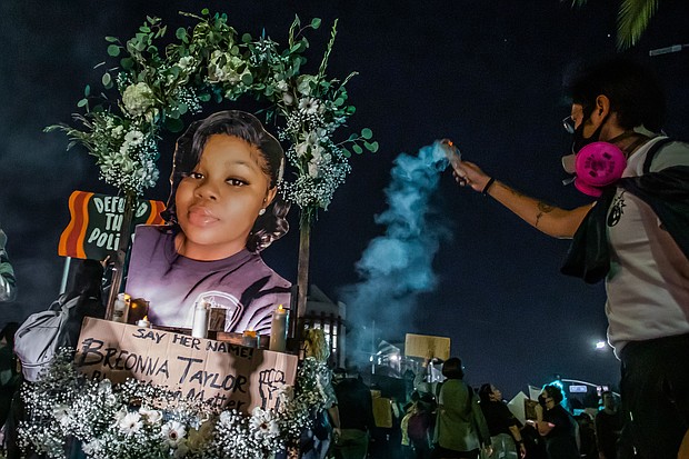Protesters march against police brutality in Los Angeles, on Sept. 23, following a decision on the Breonna Taylor case in Louisville, KY. A judge announced charges brought by a grand jury against Detective Brett Hankison, one of three police officers involved in the fatal shooting of Taylor in March./Credit:	Apu Gomes/AFP/Getty Images