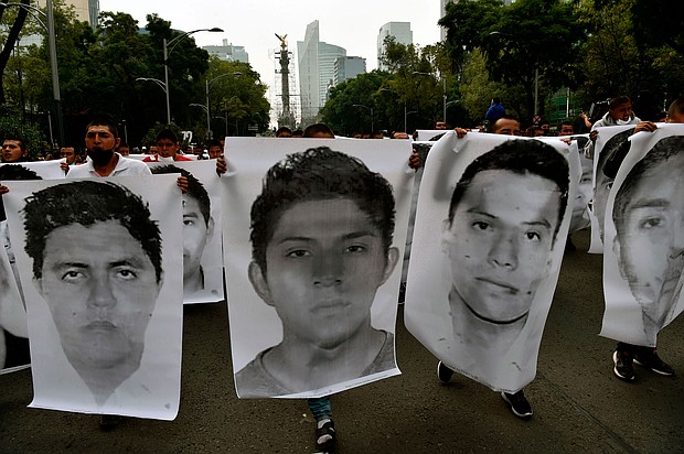 People protest in Mexico City on September 26, 2020, to mark six years of the disappearance of the 43 students of the teaching training school in Ayotzinapa who went missing on September 26, 2014./Credit:	Rodrigo Arangua/AFP/G
