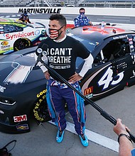 Driver Bubba Wallace is interviewed before a NASCAR Cup Series auto race June 10 in Martinsville.