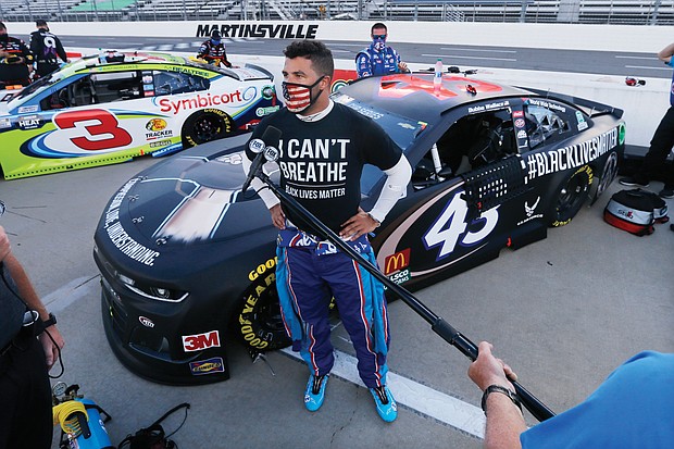 Driver Bubba Wallace is interviewed before a NASCAR Cup Series auto race June 10 in Martinsville.