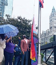 Mayor Levar M. Stoney prepares to raise the Progress Pride flag outside City Hall’s Broad Street entrance. It is the first time a symbol of the gay community has flown outside the 18-story municipal center in Downtown. The multicolored flag went up last Friday in recognition of Richmond’s annual PrideFest weekend and flew through Wednesday when Virginia PrideFest Month ended. The mayor stated the flag was raised to let LGBTQ Richmonders “know that this city stands behind them.” 
The Progress Pride flag was chosen because, along with traditional rainbow colors, it incorporates additional stripes to symbolize the inclusion of African-Americans, Latinos, people of color, transgender individuals and those living with HIV/AIDS. Lacette Cross and Louise “Cheezi” Farmer, founders of Black Pride RVA, were among the participants at the upbeat ceremony. Black Pride RVA also received Virginia Pride’s annual Firework Award for being catalysts for community change.