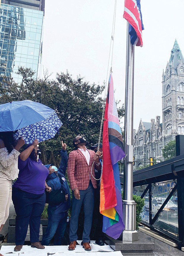 Mayor Levar M. Stoney prepares to raise the Progress Pride flag outside City Hall’s Broad Street entrance. It is the first time a symbol of the gay community has flown outside the 18-story municipal center in Downtown. The multicolored flag went up last Friday in recognition of Richmond’s annual PrideFest weekend and flew through Wednesday when Virginia PrideFest Month ended. The mayor stated the flag was raised to let LGBTQ Richmonders “know that this city stands behind them.” 
The Progress Pride flag was chosen because, along with traditional rainbow colors, it incorporates additional stripes to symbolize the inclusion of African-Americans, Latinos, people of color, transgender individuals and those living with HIV/AIDS. Lacette Cross and Louise “Cheezi” Farmer, founders of Black Pride RVA, were among the participants at the upbeat ceremony. Black Pride RVA also received Virginia Pride’s annual Firework Award for being catalysts for community change.