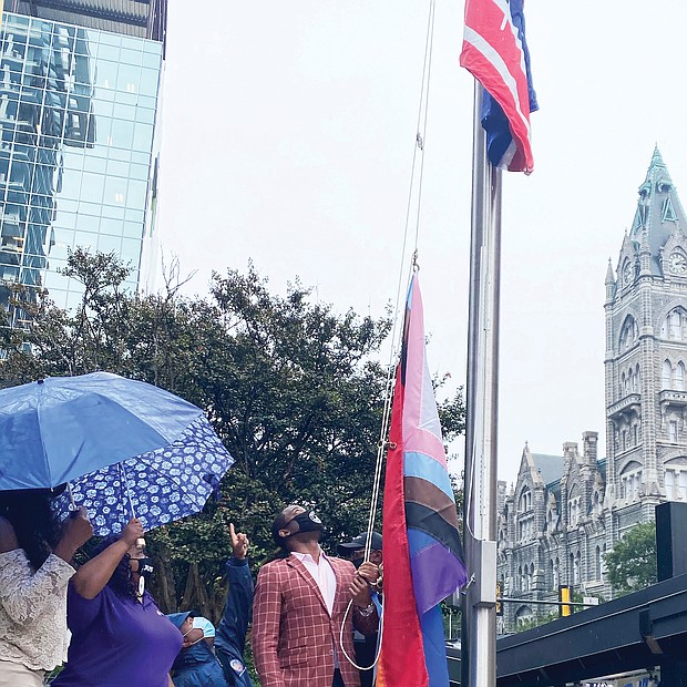 Mayor Levar M. Stoney prepares to raise the Progress Pride flag outside City Hall’s Broad Street entrance. It is the first time a symbol of the gay community has flown outside the 18-story municipal center in Downtown. The multicolored flag went up last Friday in recognition of Richmond’s annual PrideFest weekend and flew through Wednesday when Virginia PrideFest Month ended. The mayor stated the flag was raised to let LGBTQ Richmonders “know that this city stands behind them.” 
The Progress Pride flag was chosen because, along with traditional rainbow colors, it incorporates additional stripes to symbolize the inclusion of African-Americans, Latinos, people of color, transgender individuals and those living with HIV/AIDS. Lacette Cross and Louise “Cheezi” Farmer, founders of Black Pride RVA, were among the participants at the upbeat ceremony. Black Pride RVA also received Virginia Pride’s annual Firework Award for being catalysts for community change.