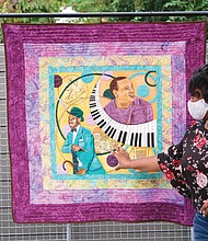 Richmond quilt artist Unicia Buster, who was commissioned to create the official poster for this year’s 2nd Street Festival, displays her creation that was photographed for the festival poster. Venture Richmond unveiled the official work at an event Sept. 23 at the Visual Arts Center’s Cabell Courtyard.