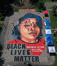In an aerial view from a drone, a large-scale ground mural depicting Breonna Taylor with the text 'Black Lives Matter' is seen being painted at Chambers Park on July 5, 2020 in Annapolis, Maryland.
Credit:	Patrick Smith/Getty Images North America/Getty Images