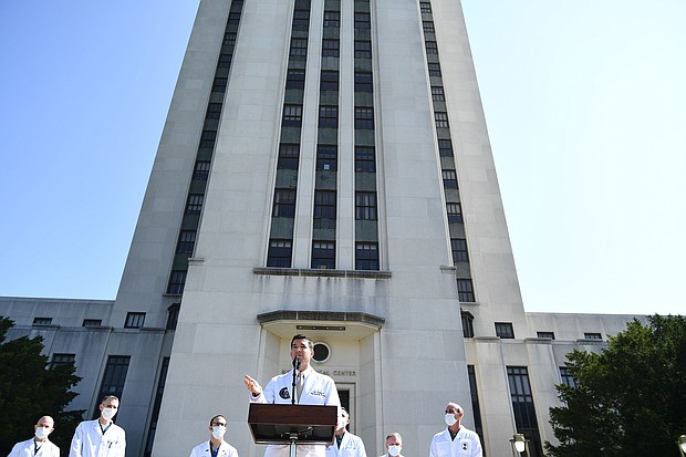 White House physician Sean Conley (C) answers questions surrounded by other doctors, during an update on the condition of President Donald Trump, on October 4, 2020, at Walter Reed Medical Center in Bethesda, Maryland.
Credit:	Brendan Smialowski/AFP/Getty Images