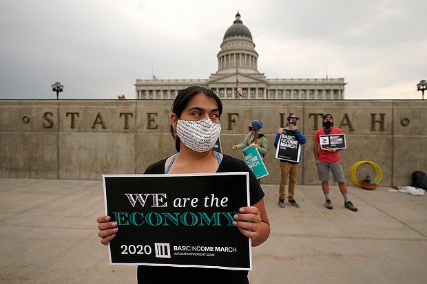 Brenda Milian gathers with other showing their support for the 2020 Basic Income March at the Utah State Capitol on Sept. 19 in Salt Lake City.
Credit:	Rick Bowmer/AP