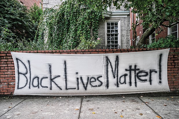 A sign of support or a statement? This homemade “Black Lives Matter” banner was spotted on a brick wall in front of a Monument Avenue residence near Allen Avenue, the intersection where the huge statue to Confederate Gen. Robert E. Lee stands on a traffic circle. The area around the statue has been the epicenter of protests over racial injustice and police brutality since May. Signs like this one and logos with BLM have become commonplace on businesses and other buildings in and near Downtown and the circle following an early spate of window-smashing, fires and looting. The signs often were posted as plea for anyone bent on destruction to spare a structure.