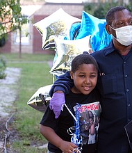 After the ceremony, right, Mr. Green receives a hug from his grandson, Mykhi Davis, 9. “I felt proud that someone recognizes the work you do for the schools,” Mr. Green said.