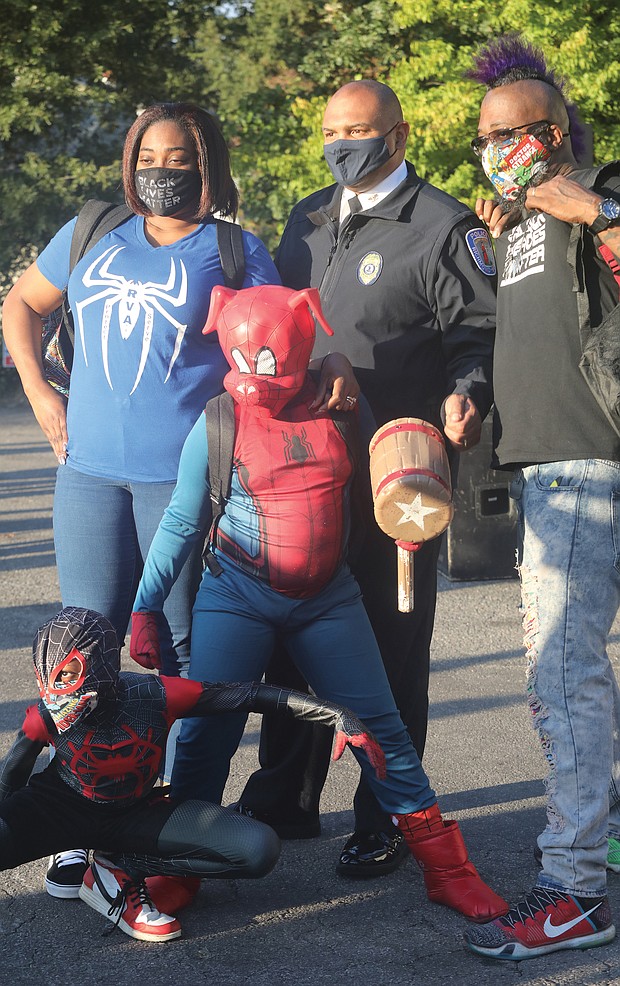 Chief Smith joins a family for a photo. Daryle Williams-Lester, left, Frank Lester, and their two sons, “Spider-Ham” Darick Williams, 11, and “Spiderman” Darian Williams, 9.