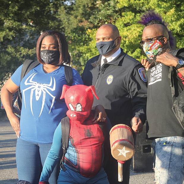 Chief Smith joins a family for a photo. Daryle Williams-Lester, left, Frank Lester, and their two sons, “Spider-Ham” Darick Williams, 11, and “Spiderman” Darian Williams, 9.