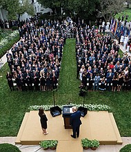 President Trump, center, stands with Judge Amy Coney Barrett at a Sept. 26 news conference to announce Judge Barrett as his nominee to the Supreme Court at the White House Rose Garden.