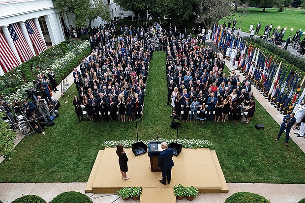 President Trump, center, stands with Judge Amy Coney Barrett at a Sept. 26 news conference to announce Judge Barrett as his nominee to the Supreme Court at the White House Rose Garden.