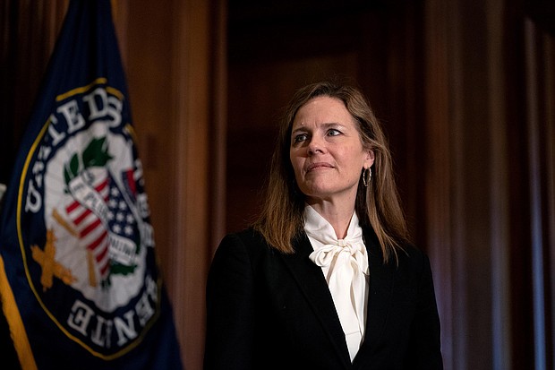 Judge Amy Coney Barrett, President Donald Trump's nominee for the US Supreme Court, meets with Republican Sen. John Hoeven, on Capitol Hill in Washington, on Oct. 1, 2020./Credit:	Stefani Reynolds/AP