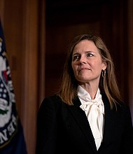 Judge Amy Coney Barrett, President Donald Trump's nominee for the US Supreme Court, meets with Republican Sen. John Hoeven, on Capitol Hill in Washington, on Oct. 1, 2020./Credit:	Stefani Reynolds/AP
