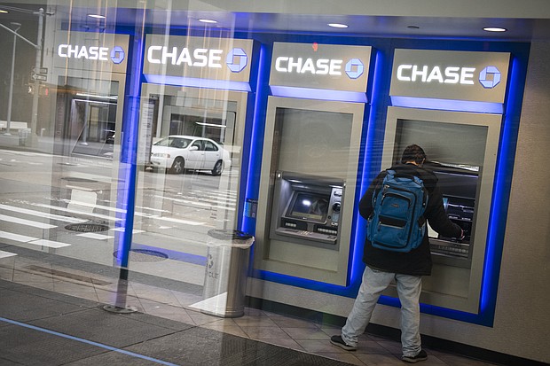A customer uses an automated teller machine (ATM) at a temporarily closed JPMorgan Chase & Co. bank branch in New York on Friday, April 10, 2020.
Credit:	Mark Kauzlarich/Bloomberg/Getty Images
