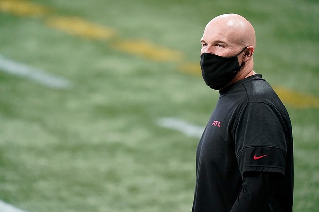 Atlanta Falcons head coach Dan Quinn walks the turf before the first half of the game against the Carolina Panthers on Sunday in Atlanta.
Credit:	Brynn Anderson/AP