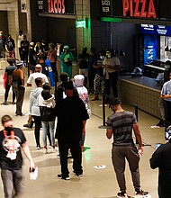People wait in line to vote early at the State Farm Arena on Monday, Oct. 12, 2020, in Atlanta.
Credit:	Brynn Anderson/AP