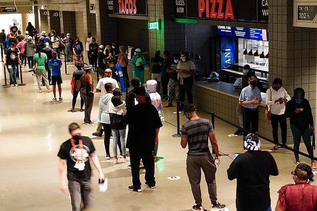 People wait in line to vote early at the State Farm Arena on Monday, Oct. 12, 2020, in Atlanta.
Credit:	Brynn Anderson/AP