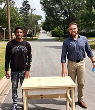 Marty Coyle (right) is an industrial technology teacher at Hillcrest High School who decided to make desks for students who needed them while they are remote learning due to COViD-19. Antwan Bell (left), a senior at Hillcrest High School, is a student in Coyle’s class who received a desk. Photo courtesy
of Bremen High School District 228