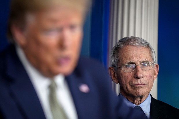 President Donald Trump, joined by members of the Coronavirus Task Force, speaks as National Institute Of Allergy And Infectious Diseases Director Dr. Anthony Fauci looks on during a press conference about the coronavirus outbreak in the press briefing room at the White House on March 17, 2020 in Washington, DC./Credit:	Drew Angerer/Getty Images
