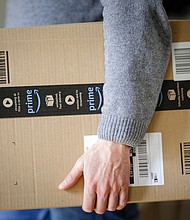 A man is holding an Amazon Prime package on March 20, 2018 in Berlin, Germany.
Credit:	Thomas Trutschel/Photothek/Getty Images