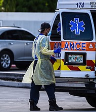 A medic prepares to transfer a patient on a stretcher from an ambulance outside of Emergency at Coral Gables Hospital where Coronavirus patients are treated in Coral Gables near Miami, on July 30, 2020.
Credit:	CHANDAN KHANNA/AFP/Getty Images