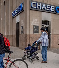 Pedestrian pass in front of a JPMorgan Chase & Co. bank branch in the Midwood neighborhood in the Brooklyn borough of New York on September 24, 2020.
Credit:	Amir Hamja/Bloomberg/Getty Images