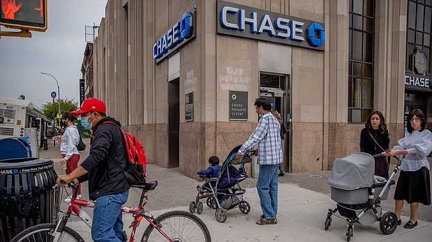 Pedestrian pass in front of a JPMorgan Chase & Co. bank branch in the Midwood neighborhood in the Brooklyn borough of New York on September 24, 2020.
Credit:	Amir Hamja/Bloomberg/Getty Images