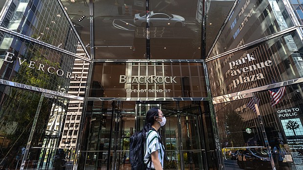 A pedestrian wearing a protective mask walks past BlackRock Inc. headquarters in New York on July 9, 2020./Credit:	Jeenah Moon/Bloomberg/Getty Images