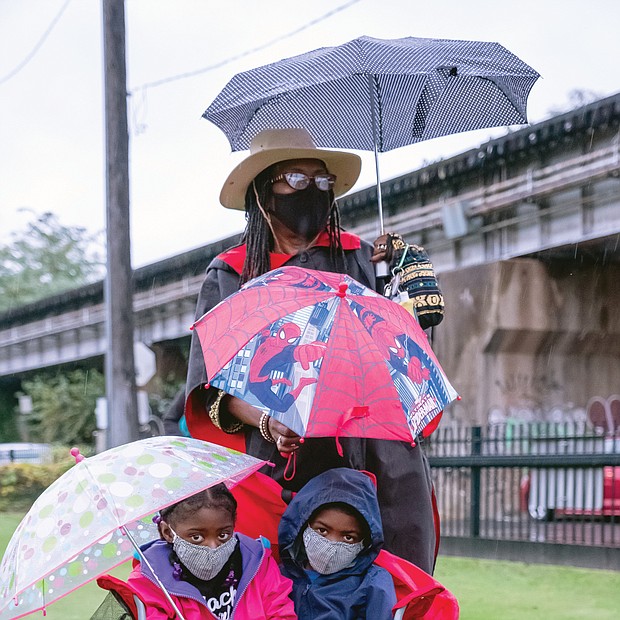 Sydney Woodson, 6, left, and her brother, Kailin Woodson, 7, attend the 18th Annual Gabriel Gathering
last Saturday in Shockoe bottom commemorating the rebellion of Gabriel Prosser, an enslaved blacksmith in Henrico County in 1800. the commemoration, presented by the Sacred Ground Historical Reclamation Project, was held at the site of a planned memorial park to the enslaved. the youngsters were attending the event with their grandmother, Lenora White.