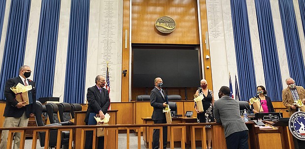 Mayor Levar M. Stoney, front center, talks with special guests at a ceremony Oct. 9 in Richmond City Council Chambers proclaiming Monday, Oct. 12, as Indigenous Peoples’ Day in the city.
This is the second year the city has honored the day, which was formerly dedicated to Christopher Columbus, who many view as exploiting indigenous people.
In June, a statue of Columbus was pulled down from its perch in Byrd Park by protesters and dragged into Fountain Lake. The city now has the statue in storage.
Guests at the ceremony are, from left, Keith Anderson of Portsmouth and Chief Samuel Bass of Suffolk, both of the Nansemond Indian Nation; Reggie Tupponce Jr. of Glen Allen, administrator of the Upper Mattaponi Indian Tribe; Shereen Waterlily of Richmond, a representative of the Mattaponi Tribe; Dr. Denise L. Walters of Henrico, a member of the Nottoway Tribe Council; and Pamunkey Chief Robert Gray of King William County.
Monday also was proclaimed Indigenous Peoples’ Day in Virginia for the first time. In a statement, Gov. Northam said the state and the nation “too often failed to live up to our commitments with those who were the first stewards of the lands we now call Virginia — and they have suffered historic injustices as a result.
“Indigenous Peoples’ Day celebrates the resilience of our tribal communities and promotes reconciliation, healing, and continued friendship with Virginia’s Indian tribes,” the statement continued.
“In making this proclamation, we pay tribute to the culture, history, and many contributions of Virginia Indians and recommit to cultivating strong government-to-government partnerships that are grounded in mutual trust and respect.” Virginia is home to 11 state-recognized Indian tribes, seven of which also are federally recognized.