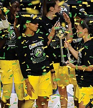 Seattle Storm guard Sue Bird shows the trophy to some of her teammates Oct. 6 after the team defeated the Las Vegas Aces to win the WNBA championship 2020, in Bradenton, Fla.