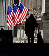 Pedestrians pass the New York Stock Exchange Wednesday, Oct. 14, 2020, in New York.
Credit:	Frank Franklin II/AP