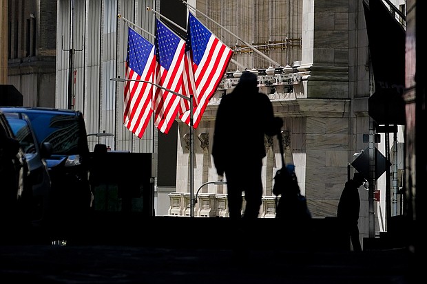 Pedestrians pass the New York Stock Exchange Wednesday, Oct. 14, 2020, in New York.
Credit:	Frank Franklin II/AP
