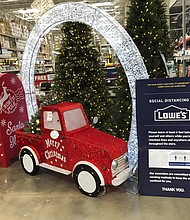 Lowe's is offering free Christmas tree delivery for the first time as home-bound Americans start the holidays earlier than usual./Credit:	David Zalubowski/AP