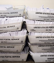 Large boxes of envelopes are seen as absentee ballot election workers stuff ballot applications at the Mecklenburg County Board of Elections office in Charlotte, North Carolina on September 4, 2020.
Credit:	Logan Cyrus/AFP/Getty Images