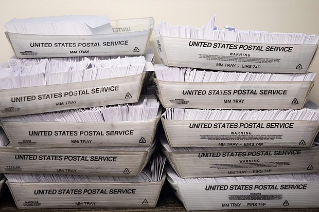 Large boxes of envelopes are seen as absentee ballot election workers stuff ballot applications at the Mecklenburg County Board of Elections office in Charlotte, North Carolina on September 4, 2020.
Credit:	Logan Cyrus/AFP/Getty Images