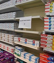 A sign is placed on partially empty shelves at a market, boycotting French goods in Kuwait City, Kuwait.
Credit:	Jaber Abdulkhaleg/Anadolu Agency/Getty Images