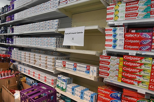 A sign is placed on partially empty shelves at a market, boycotting French goods in Kuwait City, Kuwait.
Credit:	Jaber Abdulkhaleg/Anadolu Agency/Getty Images