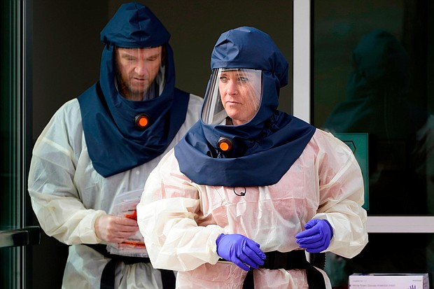 Salt Lake County Health Department public health nurses look on during coronavirus testing outside the Salt Lake County Health Department Friday, Oct. 23, 2020, in Salt Lake City, Utah. (Rick Bowmer/AP)
Credit:	Rick Bowmer/AP