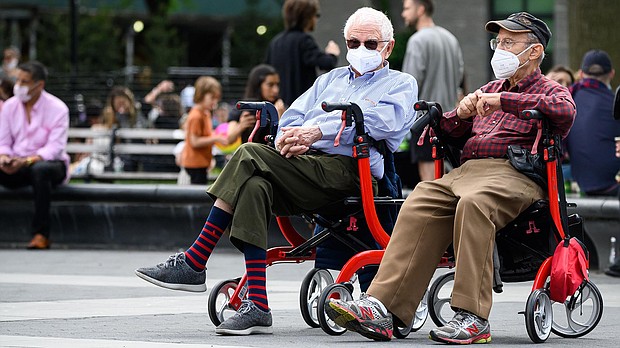 People wear protective face masks in Washington Square Park in New York City during the coronavirus pandemic.
Credit:	Noam Galai/Getty Images