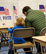 Nick Botto votes with his daughter Violet, age 3, in the state primary on February 11 in Bedford, New Hampshire.
Credit:	Matthew Cavanaugh/Getty Images