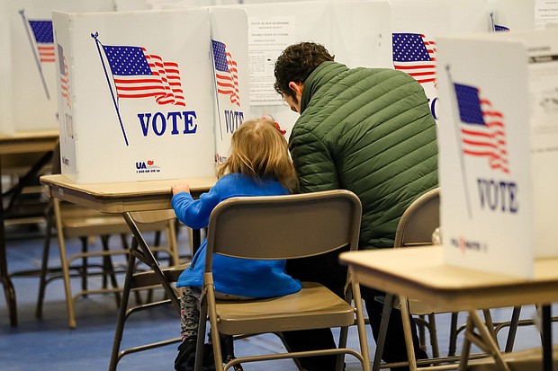 Nick Botto votes with his daughter Violet, age 3, in the state primary on February 11 in Bedford, New Hampshire.
Credit:	Matthew Cavanaugh/Getty Images