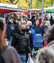 People wear protective masks as they shop at an outside market in the Neukoelln district during the second wave of the coronavirus pandemic on Oct. 27 in Berlin, Germany.
Credit:	Maja Hitij/Getty Images